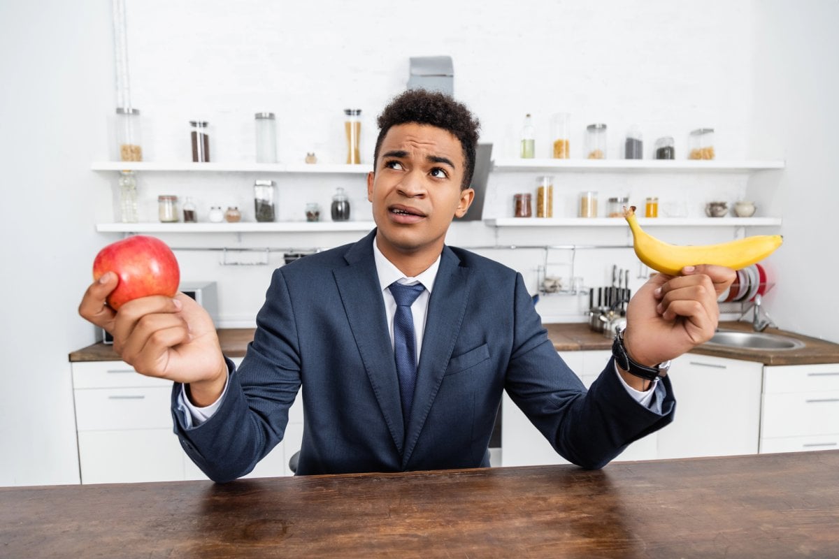 Man choosing choice banana apple