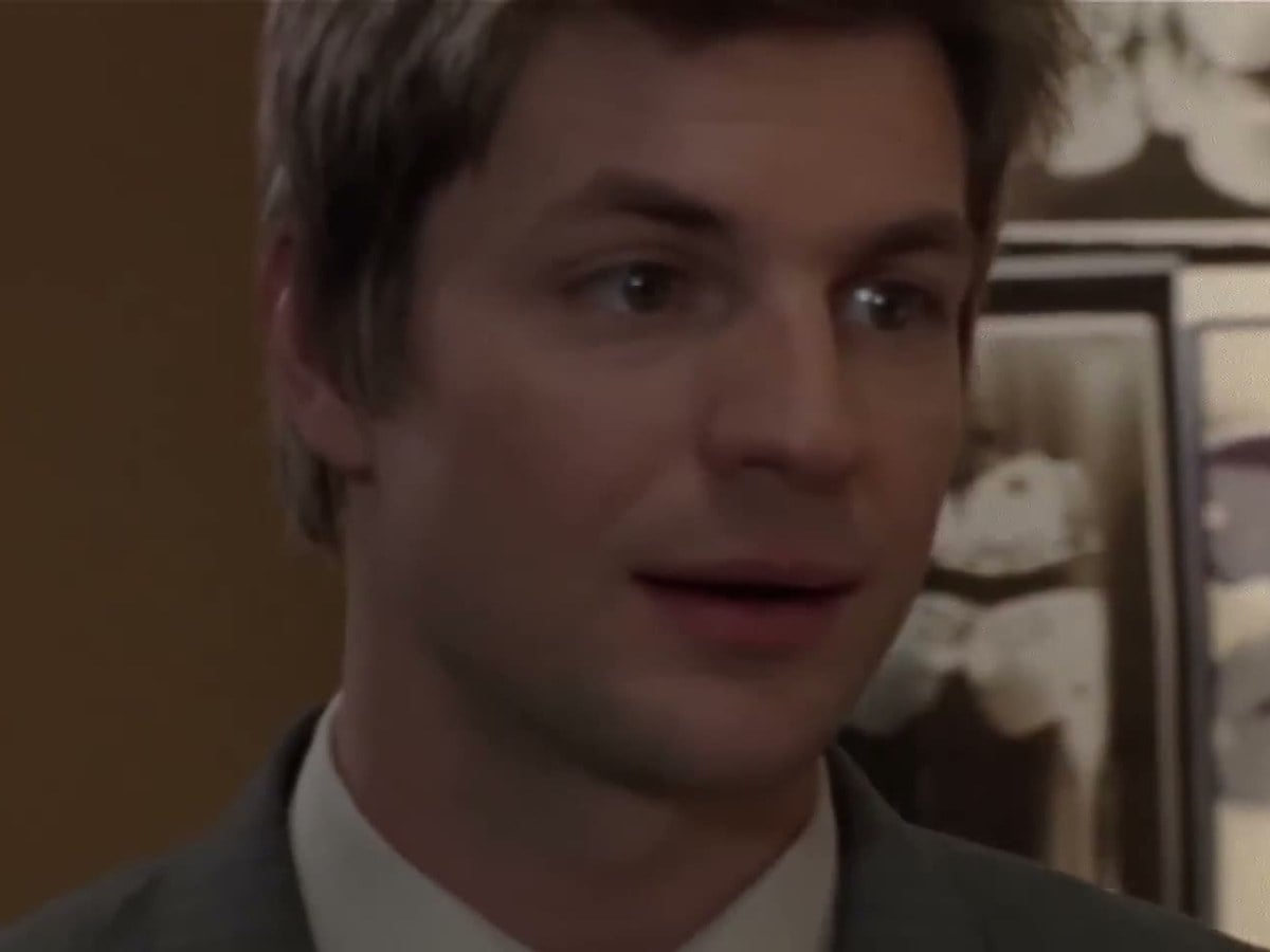 Gale Harold as Brian Kinney in a gray suit in Queer as Folk