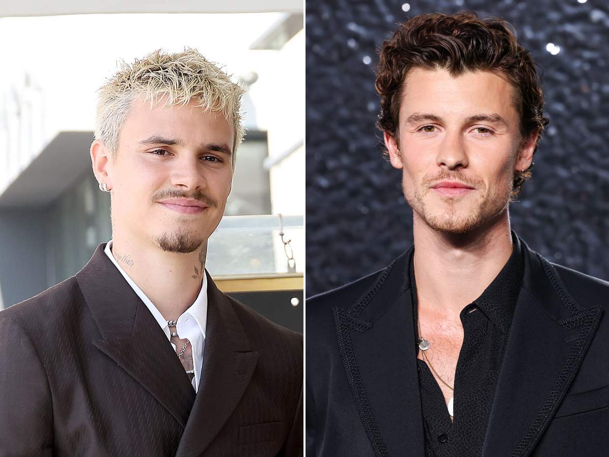 Side-by-side photos of Romeo Beckham with bleached blond hair in a brown suit and Shawn Mendes in a black suit and open black shirt