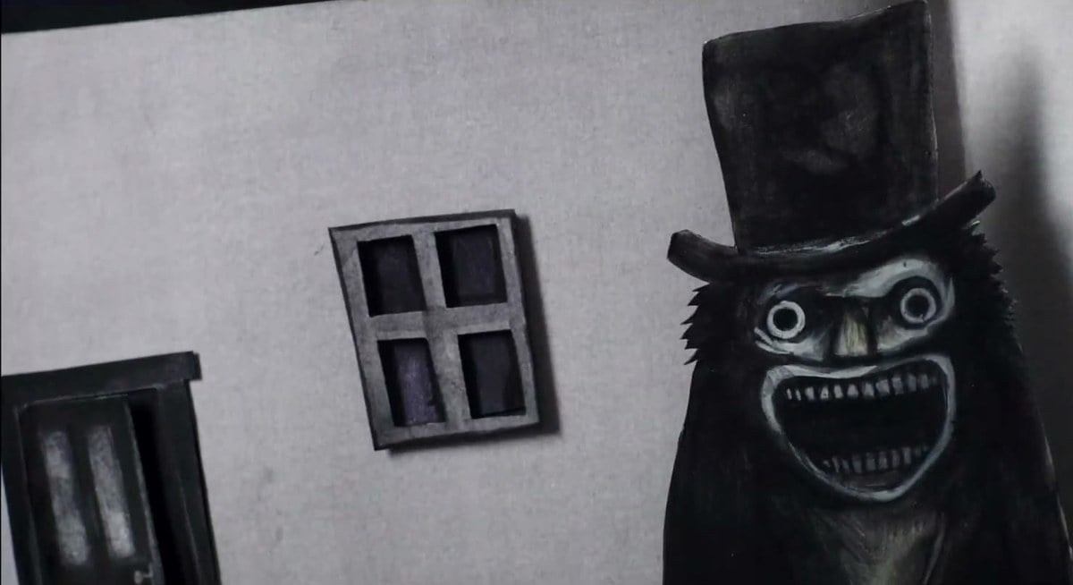 The Babadook, a grinning black figure in a top hat, drawn in his pop-up book
