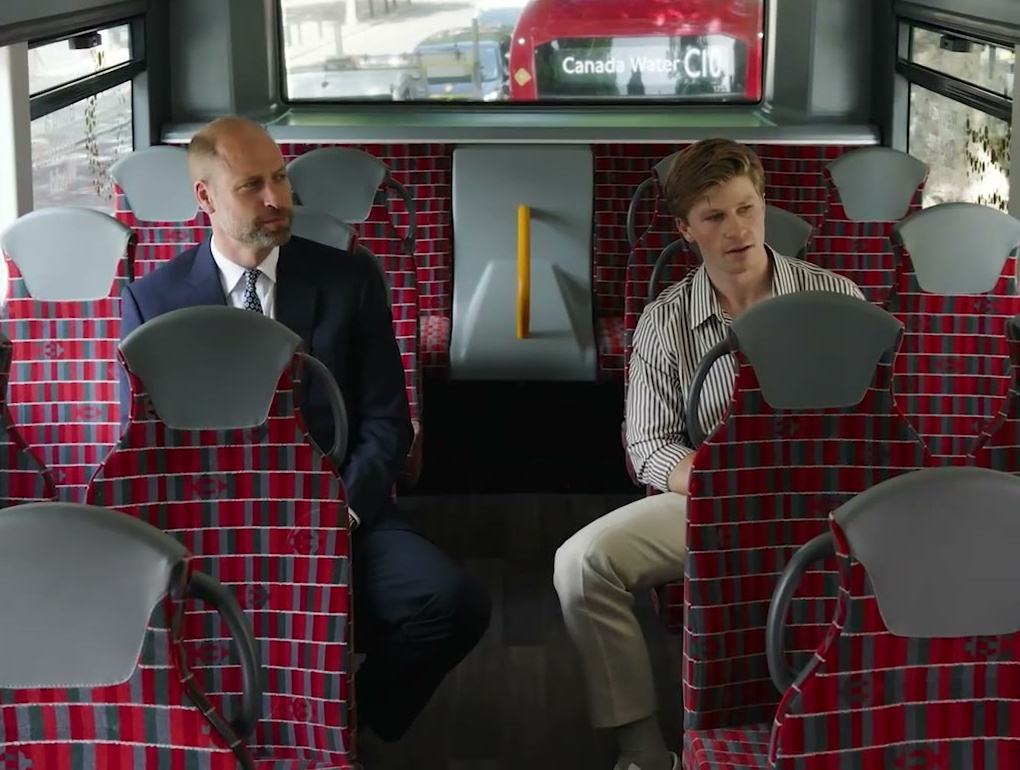 Prince William and Robert Irwin sitting on the top deck of an Earthshot Prize bus in London