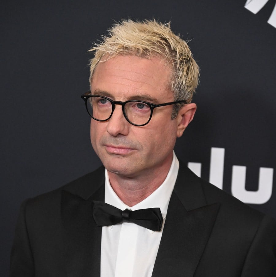 Jacob Tierney in glasses and a tuxedo with a bow tie