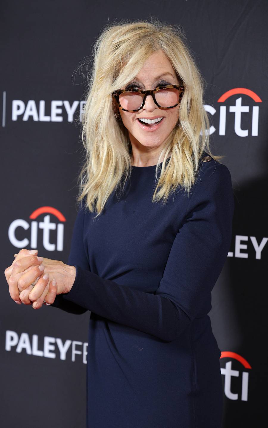 Judith Light smiling in glasses and a navy dress at PaleyFest