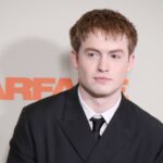 Kit Connor in a black suit and tie at the Warfare premiere