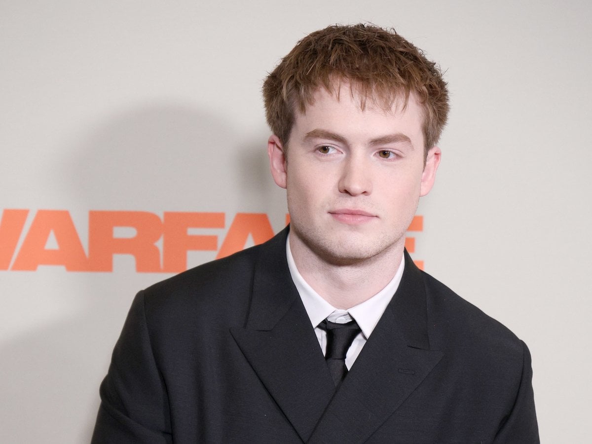 Kit Connor in a black suit and tie at the Warfare premiere