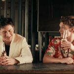 Hudson Williams and Connor Storrie as Shane and Ilya sharing beers at a bar