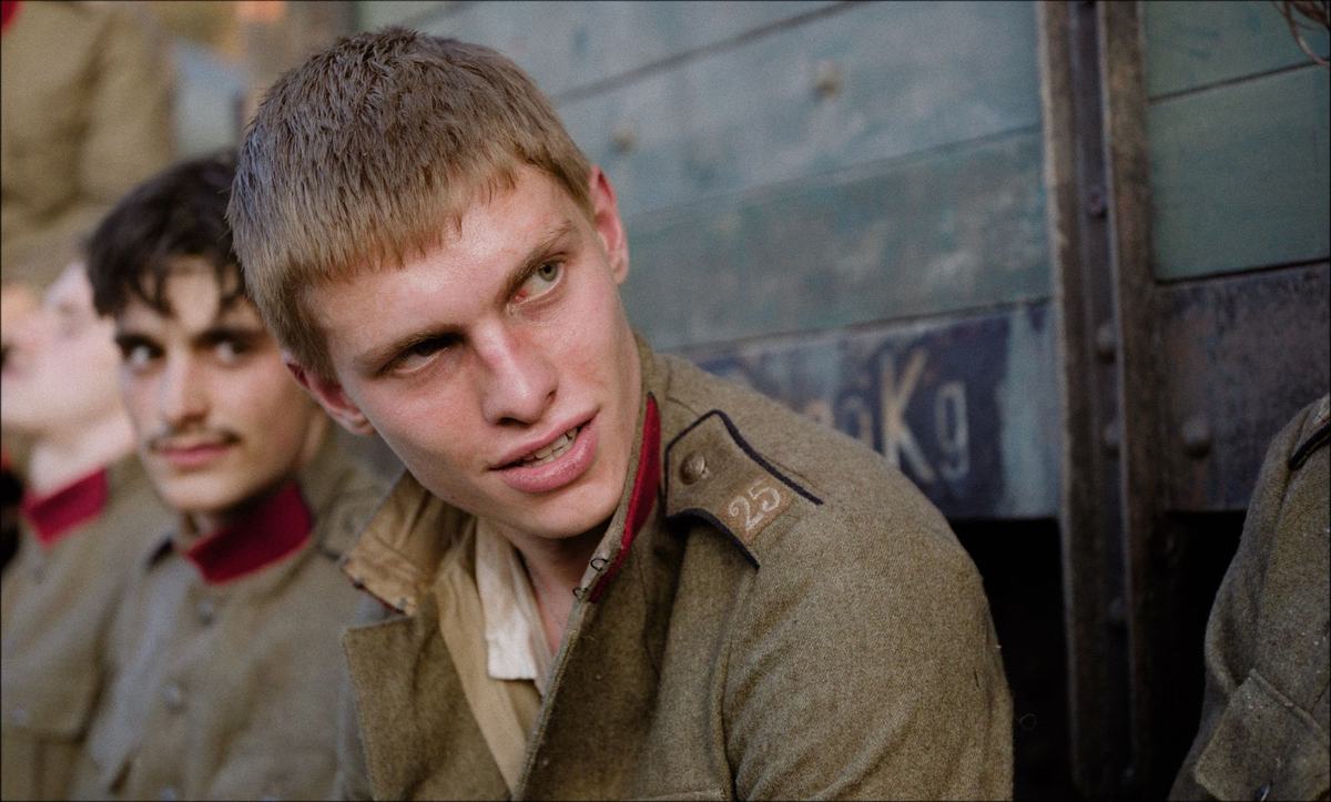 Young Belgian soldiers in uniform by a railway wagon in Coward