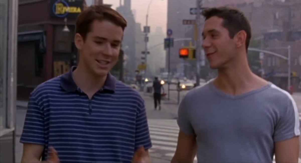 Christian Campbell in a striped polo shirt and John Paul Pitoc in a gray T-shirt talking on a New York street in Trick