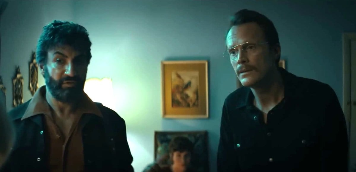 Peter Macdissi and Paul Bettany in a dimly lit room in Uncle Frank
